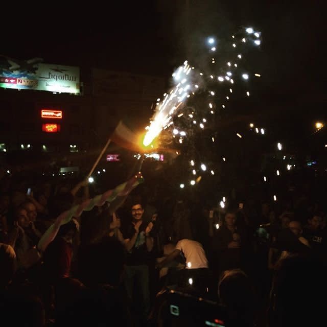 People celebrate in Tehran on Tuesday, July 14, 2015. 