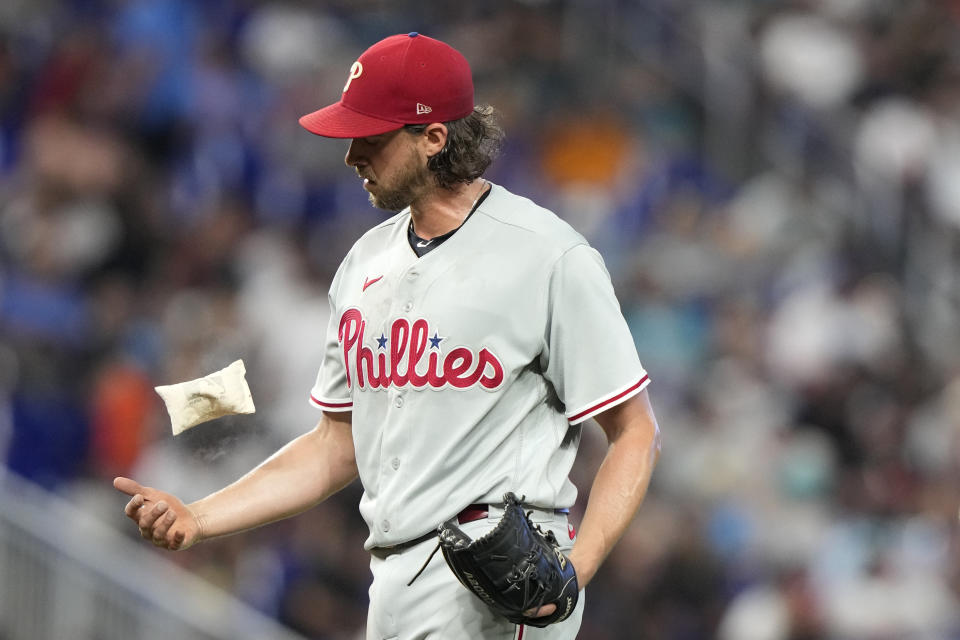 Philadelphia Phillies starting pitcher Aaron Nola tosses the rosin bag during the third inning of a baseball game against the Miami Marlins, Sunday, July 9, 2023, in Miami. (AP Photo/Lynne Sladky)