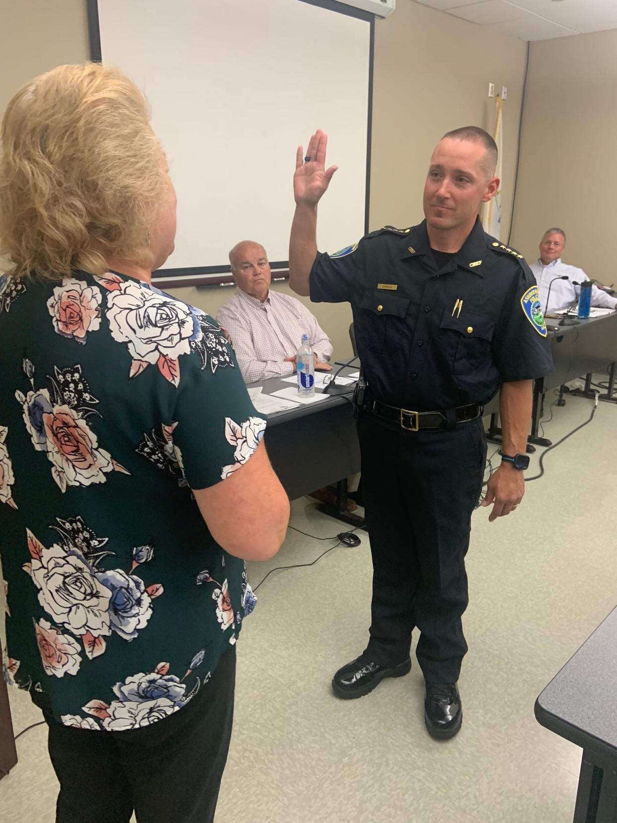 Ashburnham Chief of Police Chris Conrad takes his oath of office at his public swearing-in ceremony with Town Clerk Michelle Johnson on Aug. 8.