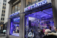 Pedestrians pass the storefront of Peter Nygard's Times Square headquarters, Tuesday, Feb. 25, 2020, in New York. Federal authorities on Tuesday, Feb. 25, 2020, raided the Manhattan headquarters of the Canadian fashion mogul Peter Nygard amid claims that he sexually assaulted and trafficked dozens of teenage girls and young women. (AP Photo/John Minchillo)