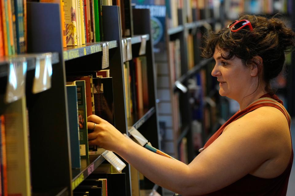 Katie Kantrowitz looks through books at Changing Hands Bookstore in Phoenix on March 27, 2024.