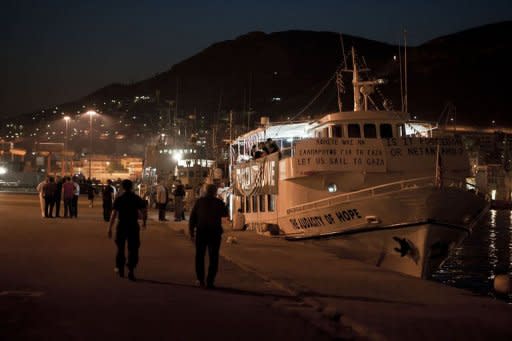 People walk past the US vessel The Audacity of Hope in the port of Athens on July 1. Greece tried to appease furious activists after halting a flotilla bound for Gaza, offering to deliver aid "through existing channels" and reaching out to the Palestinian Authority Sunday