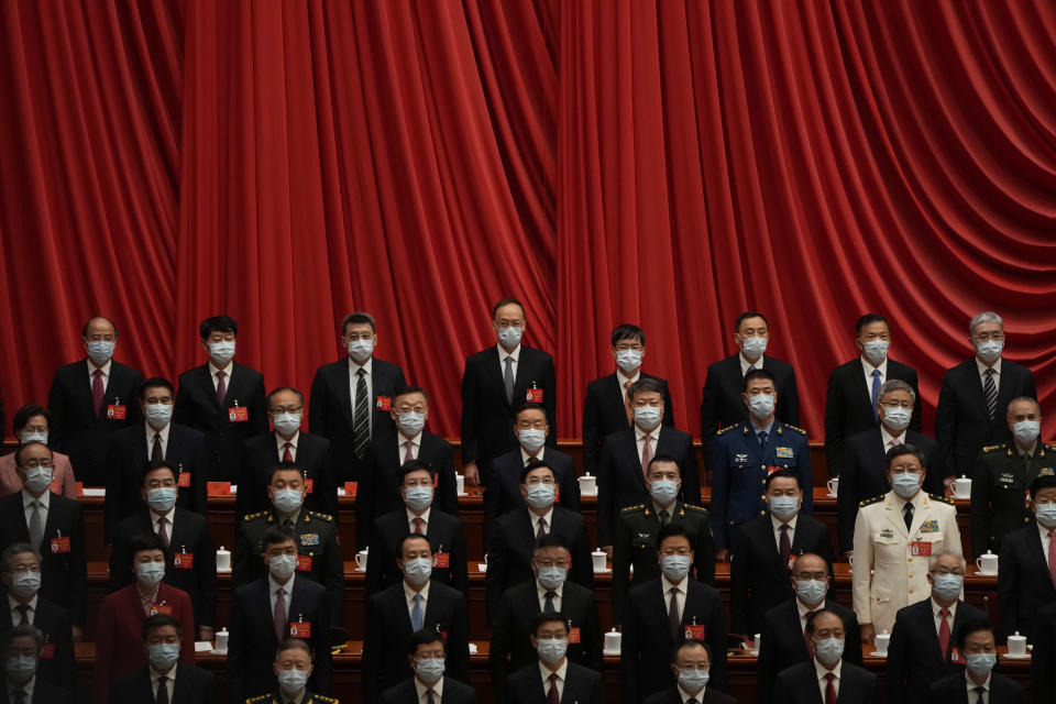 Delegates wear masks as they attend the opening ceremony of the 20th National Congress of China's ruling Communist Party held at the Great Hall of the People in Beijing, China, Sunday, Oct. 16, 2022. China on Sunday opens a twice-a-decade party conference at which leader Xi Jinping is expected to receive a third five-year term that breaks with recent precedent and establishes himself as arguably the most powerful Chinese politician since Mao Zedong. (AP Photo/Mark Schiefelbein)