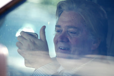 White House Chief Strategist Steve Bannon looks at a cellphone inside of a vehicle as U.S. President Donald Trump motorcade prepares to depart Mar-a-Lago estate in Palm Beach, Florida, April 9, 2017. REUTERS/Carlos Barria