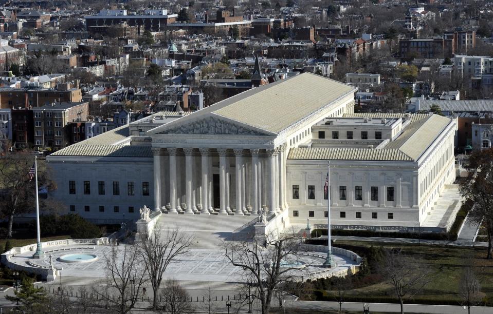 FILE - This Dec. 19, 2013, file photo shows a view of the Supreme Court from near the top of the Capitol Dome on Capitol Hill, in Washington. The Supreme Court is hearing arguments in a case that asks whether a victim of child pornography can seek millions of dollars from a defendant who had just two images of her on his computer. The woman known only as Amy is trying to persuade the justices in arguments on Jan. 22, 2014, that people convicted of possessing child pornography should be held liable for the entire cost of the harm their victims suffer, including in psychiatric care, lost income and legal fees. (AP Photo/Susan Walsh, File)