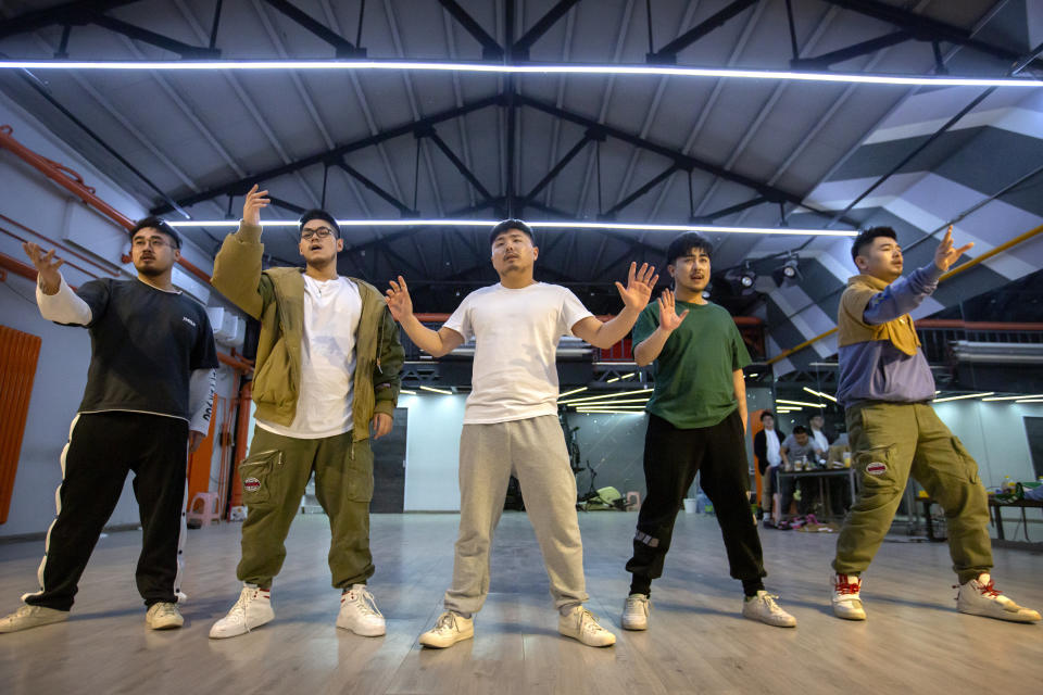 Members of the Chinese music group Produce Pandas, from left, DING, Husky, Otter, Cass, and Mr. 17 strike a pose while practicing dance choreography during rehearsals in Beijing, Thursday, April 15, 2021. The Produce Pandas proudly call themselves "the first plus-sized boy band in China." That's a radical departure from the industry standard set by Korean super groups such as BTS, whose lanky young members are sometimes referred to in China as "little fresh meat." (AP Photo/Mark Schiefelbein)