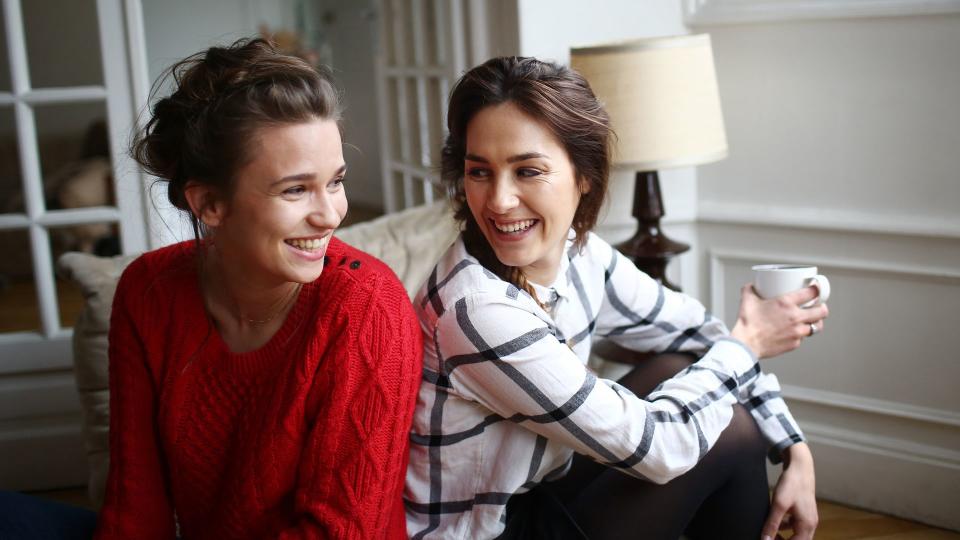 Two friends laughing together