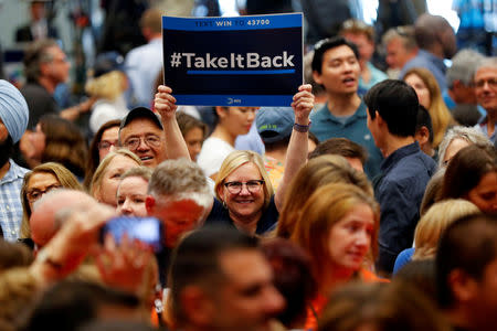 FILE PHOTO: A woman in the crowd holds up a "Take It Back" sign as she attends a political rally with former U.S. President Barack Obama for California Democratic candidates in Anaheim, California, U.S., September 8, 2018. REUTERS/Mike Blake/File Photo