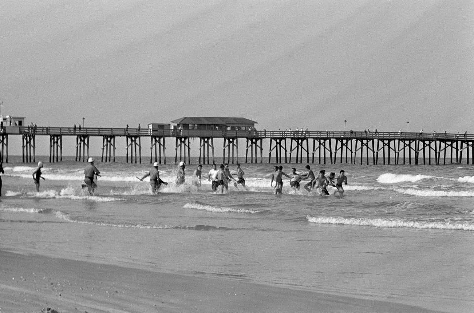 White segregationists fight with white integrationists after they entered St. Augustine Beach with black people, June 20, 1964.