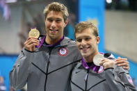 (L-R) Gold medalist <a href="http://sports.yahoo.com/olympics/swimming/matthew-grevers-1133007/" data-ylk="slk:Matt Grevers;elm:context_link;itc:0;sec:content-canvas" class="link ">Matt Grevers</a> of the United States and silver medalist <a href="http://sports.yahoo.com/olympics/swimming/nick-thoman-1124656/" data-ylk="slk:Nick Thoman;elm:context_link;itc:0;sec:content-canvas" class="link ">Nick Thoman</a> of the United States celebrate with their medals during the medal ceremony for the Men's 100m Backstroke on Day 3 of the London 2012 Olympic Games at the Aquatics Centre on July 30, 2012 in London, England. (Photo by Clive Rose/Getty Images)