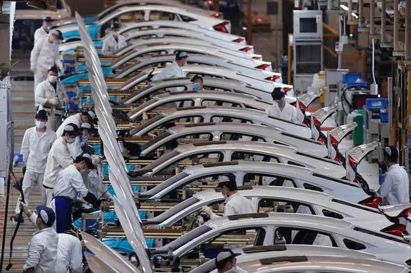 Employees work on a production line inside a Dongfeng Honda factory in Wuhan