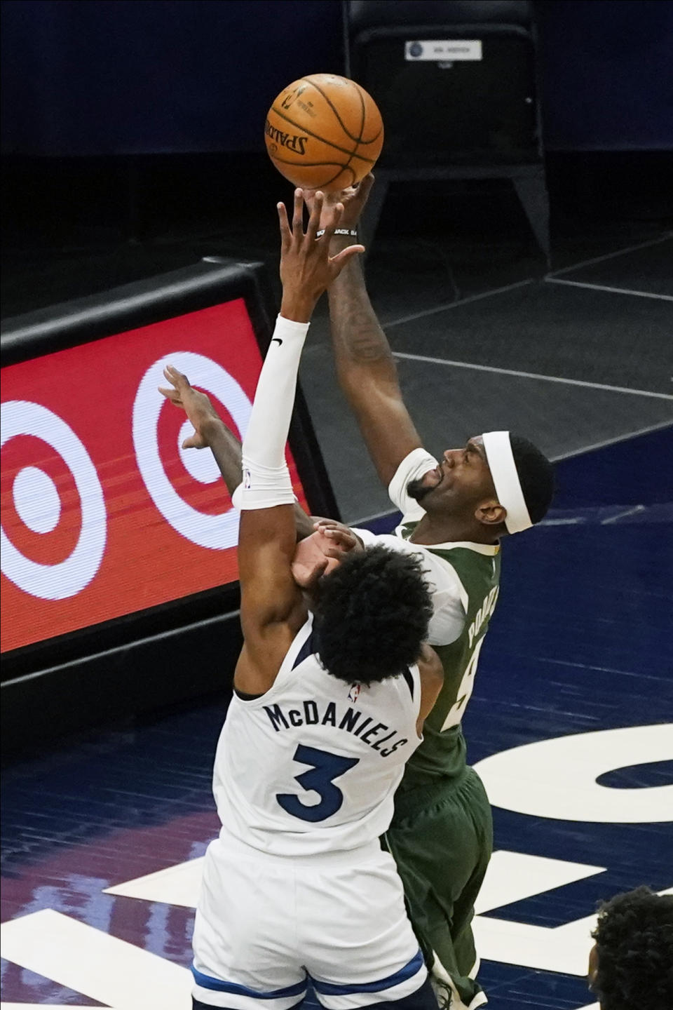 Milwaukee Bucks' Bobby Portis (9) shoots over Minnesota Timberwolves' Jaden McDaniels (3) in the first half of an NBA basketball game Wednesday, April 14, 2021, in Minneapolis. (AP Photo/Jim Mone)