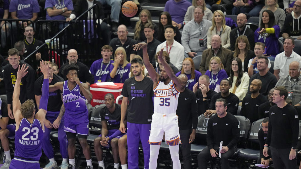 Phoenix Suns forward Kevin Durant (35) shoots a 3-pointer over Utah Jazz forward Lauri Markkanen (23) during the second half of an NBA basketball in-season tournament game Friday, Nov. 17, 2023, in Salt Lake City. (AP Photo/Rick Bowmer)