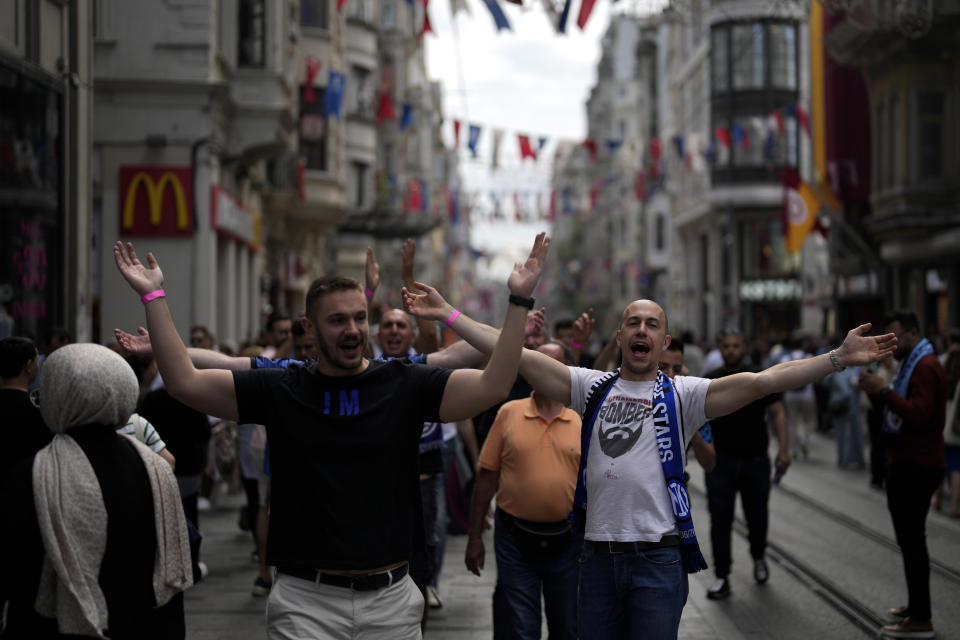 Supporters of Inter Milan chant slogans as they walk at Taksim square in Istanbul, Turkey, Friday, June 9, 2023. Manchester City will play Inter Milan in the final of the Champions League on Saturday June 10 in Istanbul.(AP Photo/Khalil Hamra)