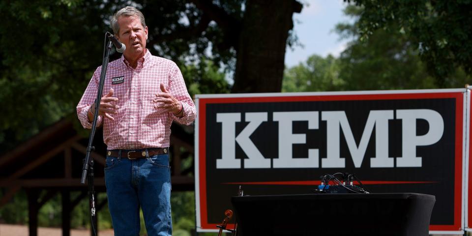 Georgia Gov. Brian Kemp, a large Kemp for Governor sign at his back, addresses supporters during a campaign rally in Watkinsville, Georgia.