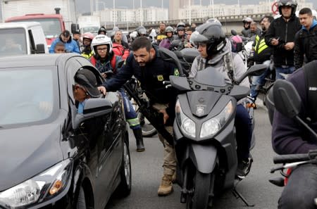 A federal police officer blocks the Rio-Niteroi Bridge, where armed police surrounded a hijacked passenger bus in Rio de Janeiro