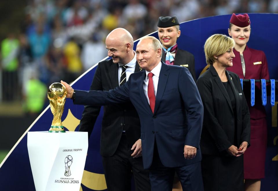 President of Russia Vladimir Putin touches the World Cup (Getty Images)