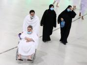 Muslim pilgrims wear protective face masks to prevent contracting coronavirus, as they arrive at the Grand mosque in the holy city of Mecca