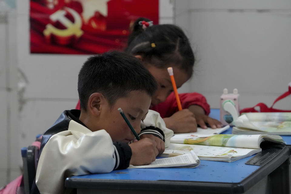 Tibetan students learn to write Tibetan words in a first-grade class at the Shangri-La Key Boarding School during a media-organized tour in Dabpa county, Kardze Prefecture, Sichuan province, China on Sept. 5, 2023. (AP Photo/Andy Wong)