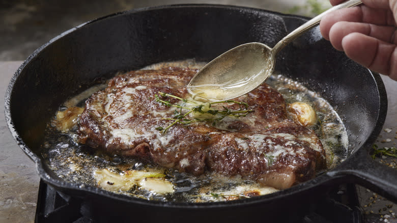 steak with butter in pan