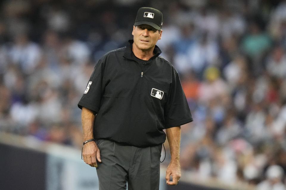 FILE - Umpire Ángel Hernández looks on during the first inning of a baseball game between the New York Yankees and the Houston Astros, Aug. 4, 2023, in New York. Longtime umpire Hernández, who unsuccessfully sued Major League Baseball for racial discrimination, is retiring immediately, announced Monday, May 27, 2024. (AP Photo/Frank Franklin II, File)