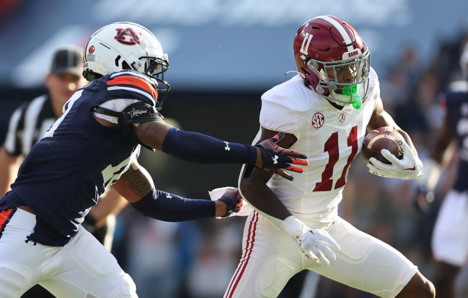 Nov 25, 2023; Auburn, Alabama, USA; Auburn Tigers safety Zion Puckett (10) closes in on Alabama Crimson Tide wide receiver Malik Benson (11) during the first quarter at Jordan-Hare Stadium. Mandatory Credit: John Reed-USA TODAY Sports