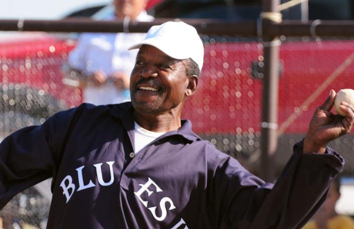 Former Kansas State football All American and Green Bay Packer Veryl Switzer switches sports to toss out the first pitch Saturday at a vintage baseball game at the Nicodemus Homecoming Emancipation Celebration where the Nicodemus Blues II played the Hodgeman 9.