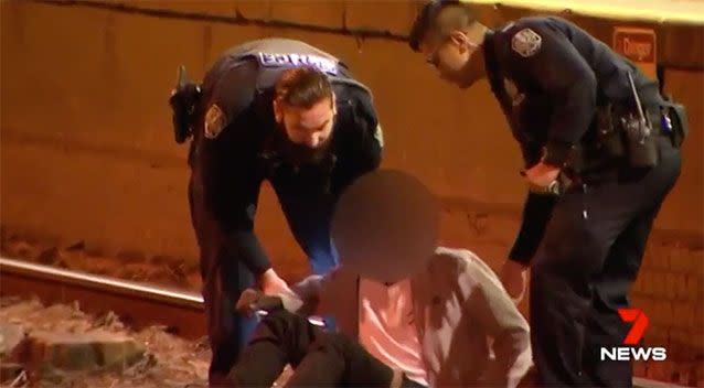 Two officers were required to remove one of the youths. Photo: 7 News