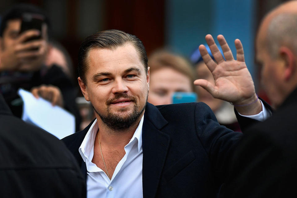 Leo DiCaprio waving at paparazzi