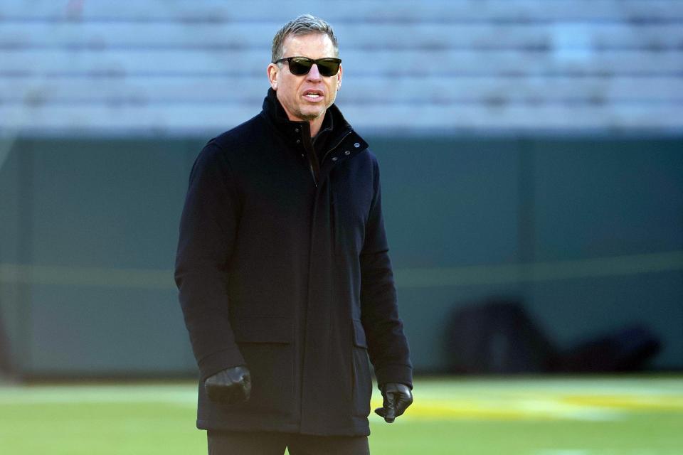 Troy Aikman walks across the field before the game between the Cleveland Browns and the Green Bay Packers at Lambeau Field on December 25, 2021 in Green Bay, Wisconsin.