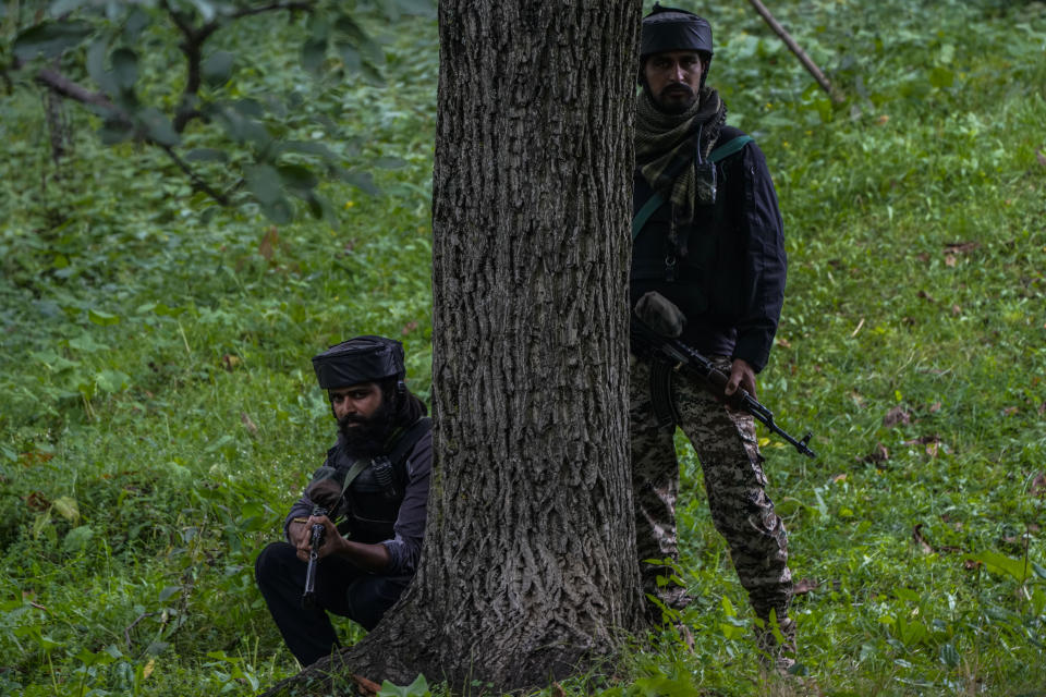 Indian soldiers keep guard near the site of attack on Sunil Kumar, a Kashmiri Hindu man locally known as Pandit, at Chotigam village, some 62 kilometers south of Srinagar, Indian controlled Kashmir, Tuesday, Aug. 16, 2022. Pandit was shot dead by suspected rebels at an apple orchard on Tuesday morning, while his brother was injured in the attack, officials said. (AP Photo/Mukhtar Khan)