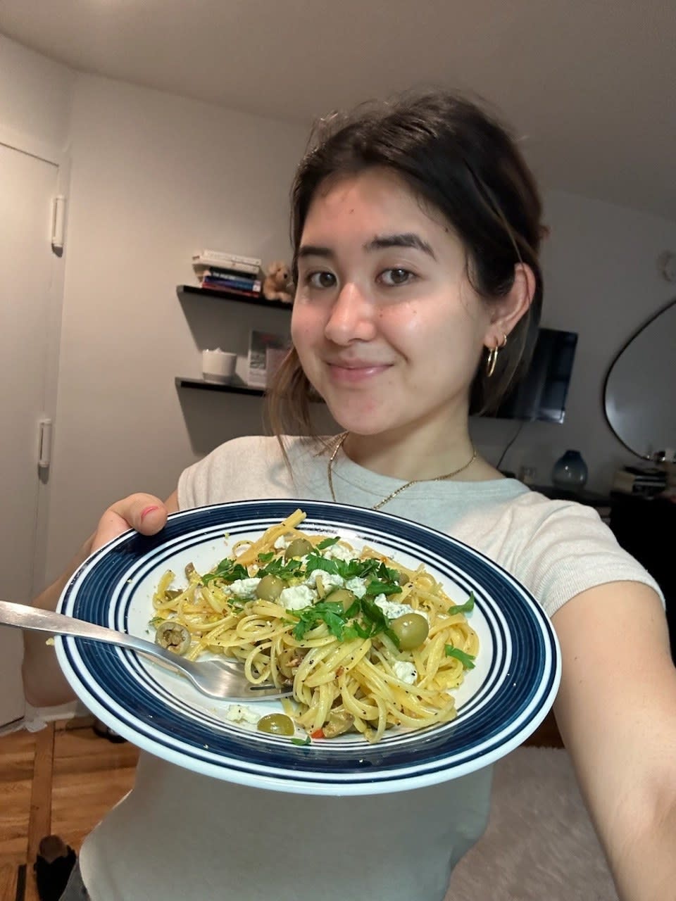 The writer holding her pasta dish