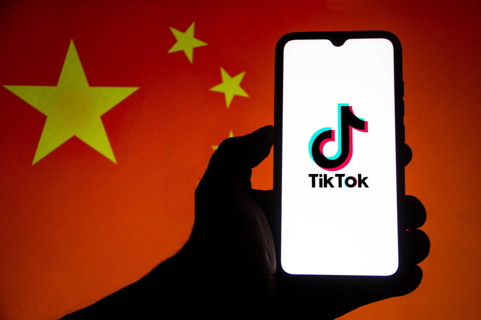 TikTok logo on phone against Chinese flag. Photo: Rafael Henrique/SOPA/LightRocket via Getty