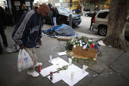 A man views a memorial for a man killed by police on skid row in Los Angeles, California, March 2, 2015. REUTERS/Lucy Nicholson