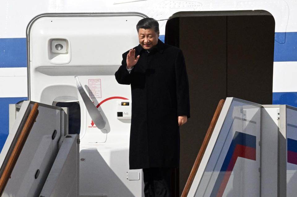 China's President Xi Jinping waves as he disembarks his aircraft upon arrival at Moscow's Vnukovo airport on March 20, 2023.