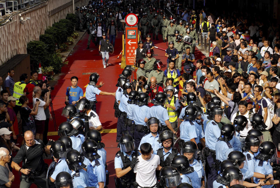 Riot police move in after fights broke out between pro-China supporters and anti-government protesters at Amoy Plaza in the Kowloon Bay district in Hong Kong, Saturday, Sept. 14, 2019. The clashes came after several nights of peaceful rallies that featured mass singing at shopping malls by supporters of the months-long protests demanding democratic reforms. (AP Photo/Vincent Yu)