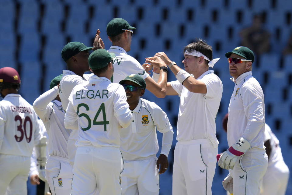 South Africa's bowler Gerald Coetzee, second from right, celebrates with teammates after dismissing West Indies's batsman Tagenarine Chanderpaul for 22 runs during the second day of the first test cricket match between South Africa and West Indies, at Centurion Park in Pretoria, South Africa, Wednesday, March 1, 2023. (AP Photo/Themba Hadebe)