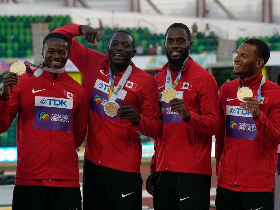 Canada's 4x100-metre relay team of (left to right) Aaron Brown, Jerome Blake, Brendon Rodney and Andre De Grasse pose during the medal ceremony after winning gold at the World Athletics Championships in Eugene, Ore., on Saturday. (Gregory Bull/The Associated Press - image credit)
