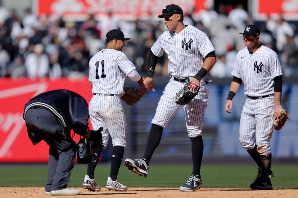 Mar 30, 2023; Bronx, New York, USA; New York Yankees shortstop Anthony Volpe (11) celebrates with center fielder Aaron Judge (99) after defeating the San Francisco Giants at Yankee Stadium. Mandatory Credit: Brad Penner-USA TODAY Sports