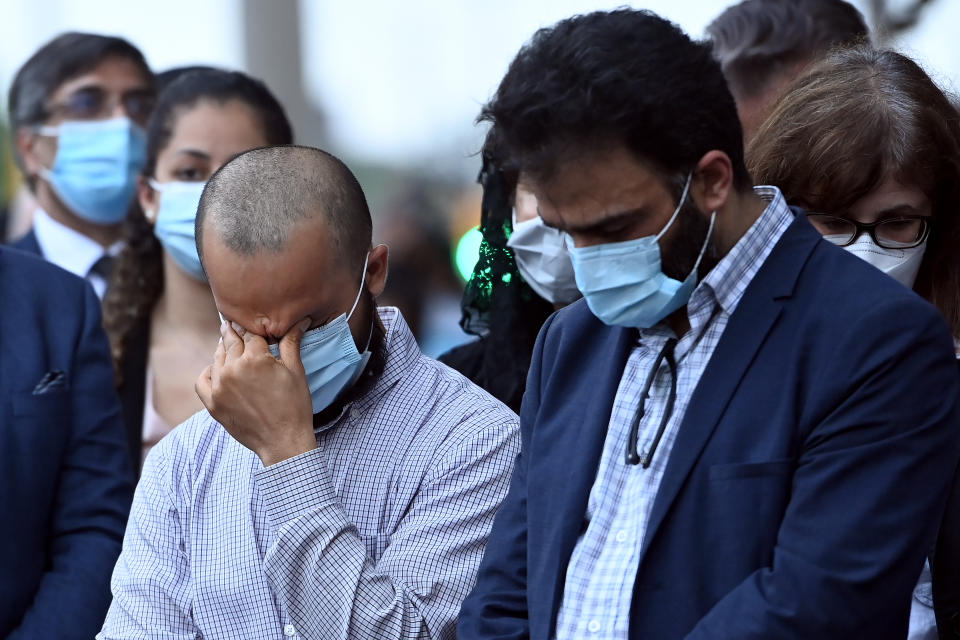 <p>Mourners react during a moment of silence at a vigil for the victims of the deadly vehicle attack on five members of the Canadian Muslim community in London, Ont., on Tuesday, June 8, 2021. Four of the members of the family died and one is in critical condition. Police have charged a London man with four counts of murder and one count of attempted murder. THE CANADIAN PRESS/Nathan Denette</p> 