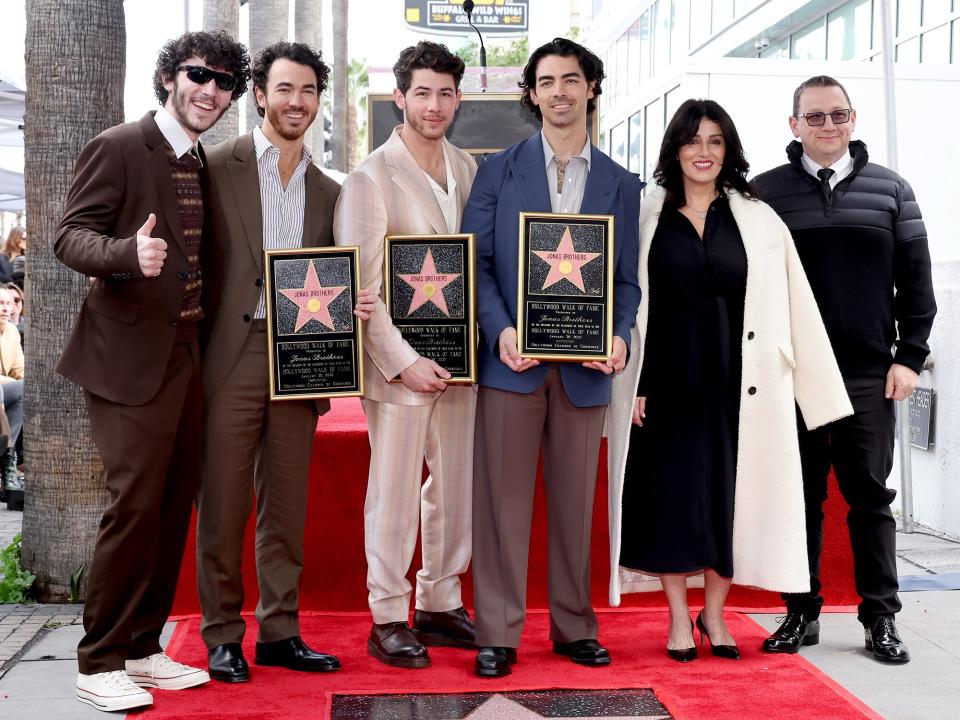 Kevin Jonas, Nick Jonas, and Joe Jonas of The Jonas Brothers, and (L-R) Frankie Jonas, Denise Miller-Jonas, and Paul Kevin Jonas Sr. attend The Hollywood Walk of Fame star ceremony honoring The Jonas Brothers on January 30, 2023 in Hollywood, California