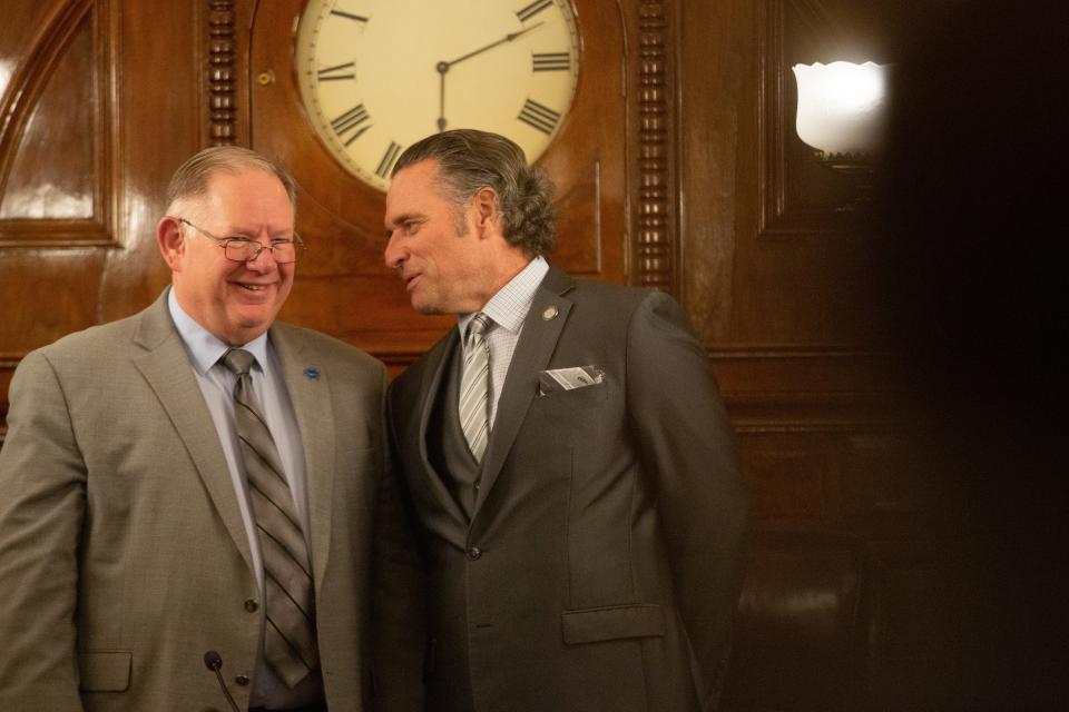 Senate President Ty Masterson, R-Andover, right, exchanges words with House Speaker Dan Hawkins, R-Wichita, before the start of Tuesday's State of the State address.