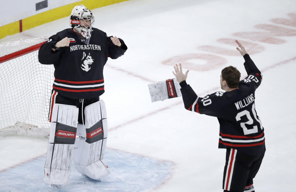 Northeastern goaltender Cayden Primeau, left, and defenseman Eric Williams, right, celebrate after defeating Boston College 4-2 in the NCAA hockey Beanpot tournament final game in Boston, Monday, Feb. 11, 2019. (AP Photo/Charles Krupa)
