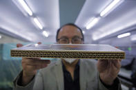 Wilson Tong, CEO of LifeArt Asia, shows a material sample of the cardboard coffin at Tong's factory in Hong Kong, Friday, March 18, 2022. Hong Kong is running short of coffins during its deadliest outbreak of the coronavirus pandemic, which has cost about 6,000 lives so far this year. LifeArt, a company in Hong Kong is trying to make an alternative, cardboard coffin, which it says is environmentally-friendly. (AP Photo/Kin Cheung)