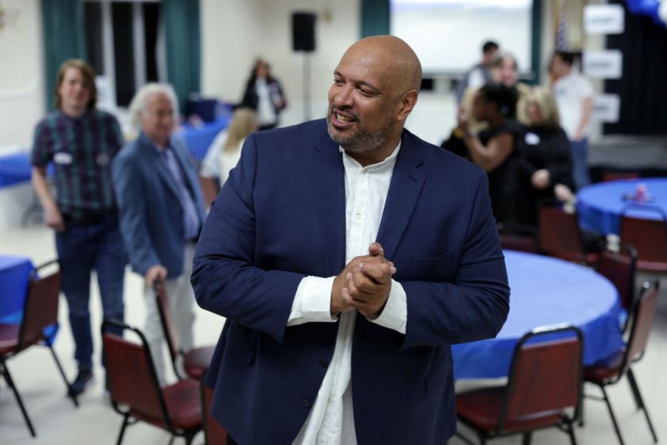 Harry Dunn, a former Capitol Police officer, greets supporters at an election night watch party on 14 May 2024 (Getty Images)