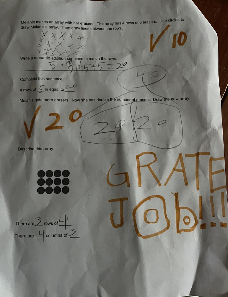 A child's homework sheet with math problems about arrays and multiplication. Large handwritten text says 