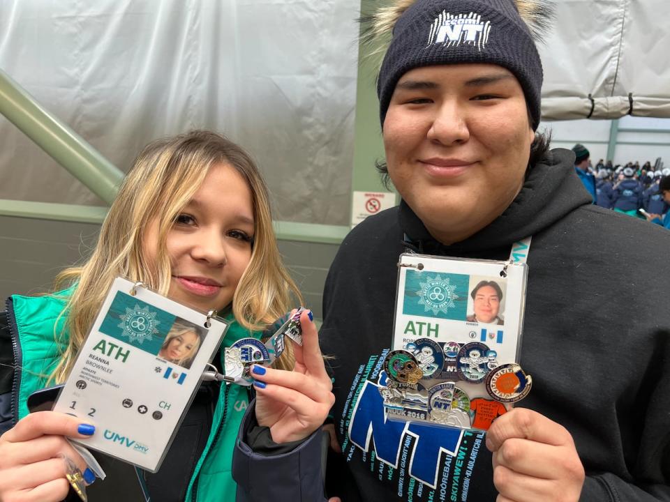 Robin Catholique and Breanna Brownlee from N.W.T. show off their pin collections.