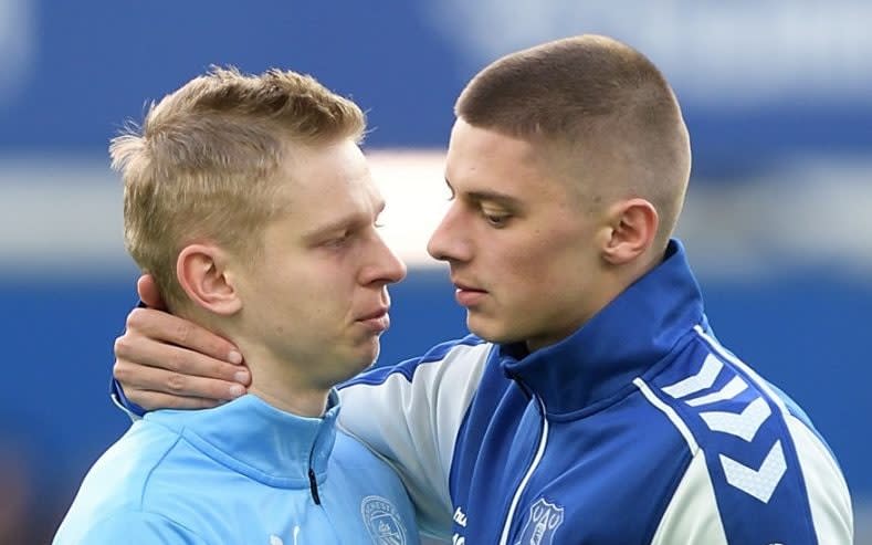 Oleksandr Zinchenko and Vitaliy Mykolenko embrace at Goodison Park - A year on, this picture remains one of the most poignant sights in football - Getty Images/Tony McArdle