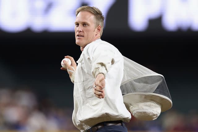<p>Christian Petersen/Getty</p> Beekeeper Matt Hilton throws out the ceremonial first pitch at the Los Angeles Dodgers vs. Arizona Diamondbacks game on April 30, 2024.