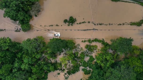 PHOTO: A truck drives along flooded Wolverine Road in Breathitt County, Ky., July 28, 2022, after heavy rains caused flash flooding and mudslides in parts of central Appalachia. (Ryan C. Hermens/Lexington Herald-Leader via AP)